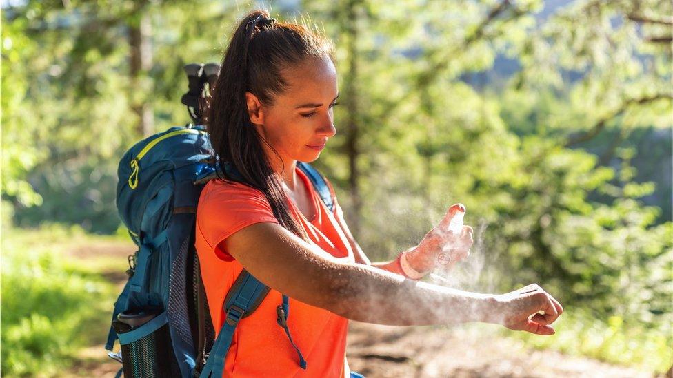 lady applying repellent