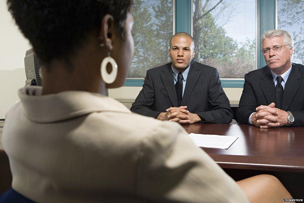 Woman being interviewed by two male colleagues