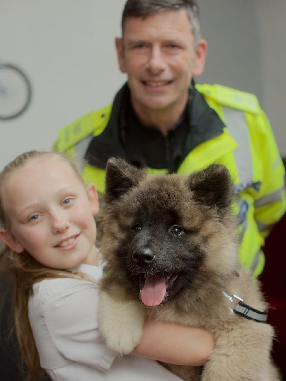 Zoe Picken and American Akita puppy Rosco and Sgt Stephen Knight