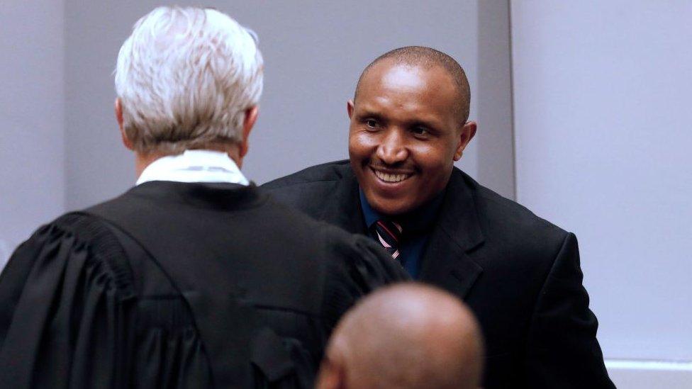 Former Congolese warlord Bosco Ntaganda (R) greets his lawyer Stephane Bourgon (L) at the courtroom of the International Criminal Court (ICC) during the closing statements of his trial in the Hague, the Netherlands, on August 28, 2018.