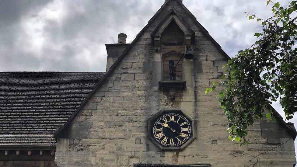 The statue sits above a clock in the centre of Stroud