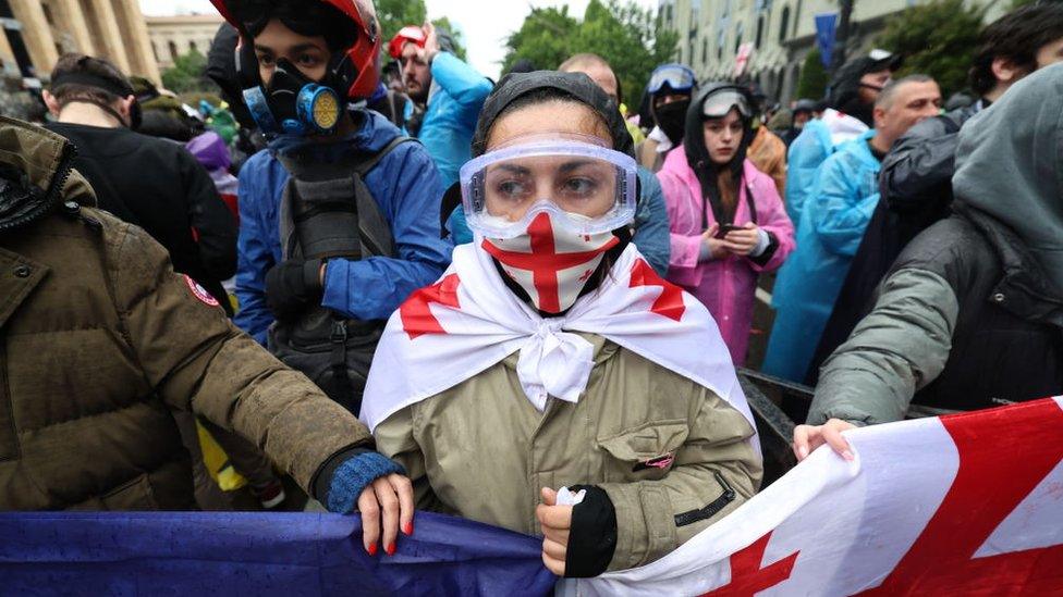 Protesters wearing protective gear