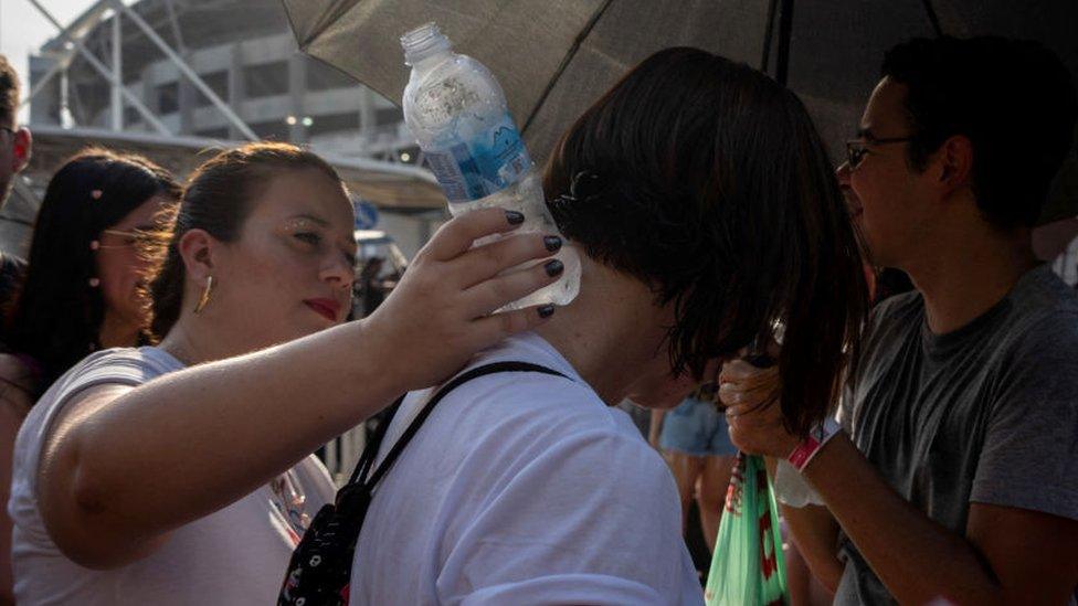 Fans of US singer Taylor Swift queue outside the Nilton Santos Olympic Stadium before Swift's concert, "Taylor Swift: The Eras Tour", amid a heat wave in Rio de Janeiro on November 18, 2023.