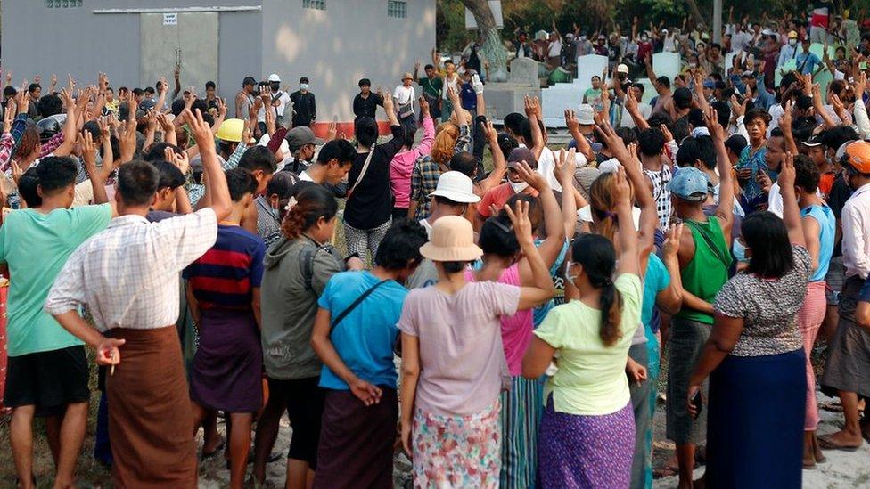 Mourners gesture the three finger salute as they attend the funeral of Tin Hla, 43, who was shot dead by security forces during a protest against the military coup in Thanlyin township, outskirts of Yangon, Myanmar on March 27, 2021.