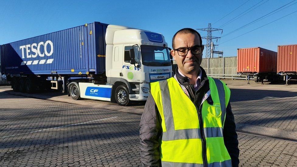 John Stevenson next to a lorry