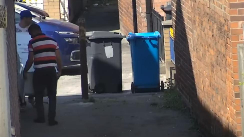 Two men with fridge