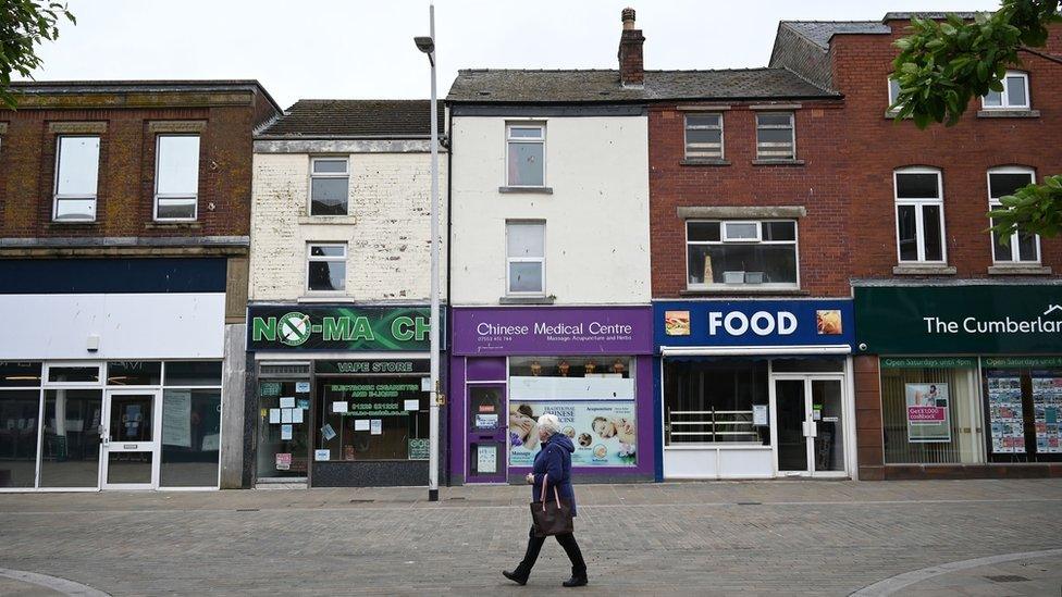 A pedestrian walks through Barrow town centre