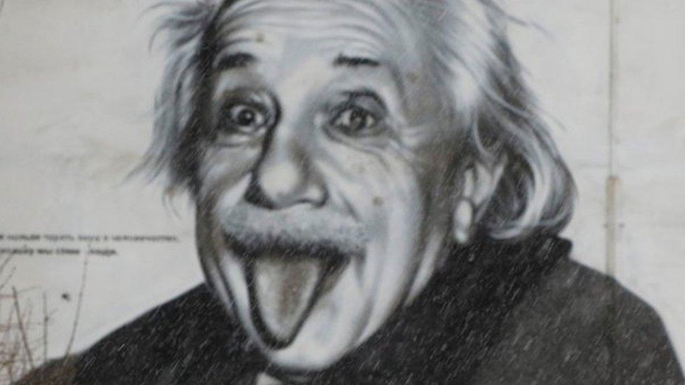 a mural of Albert Einstein sticking his tongue out