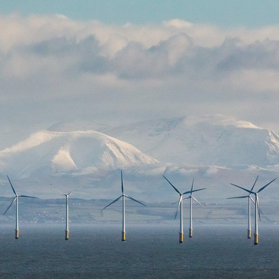 Robin Rigg Wind Farm and the Cumbrian fells from Balcary Point, Dumfries and Galloway, Scotland.