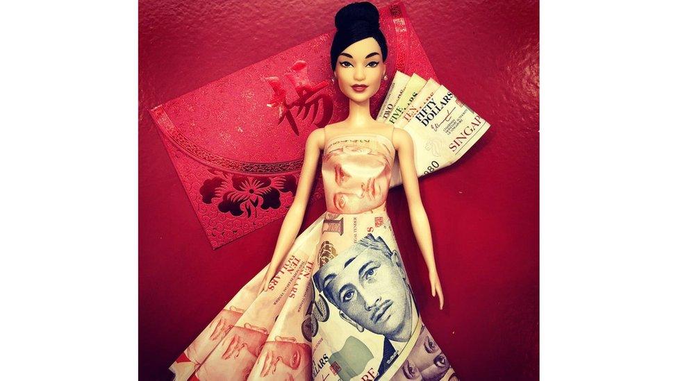 A doll dressed in notes of money