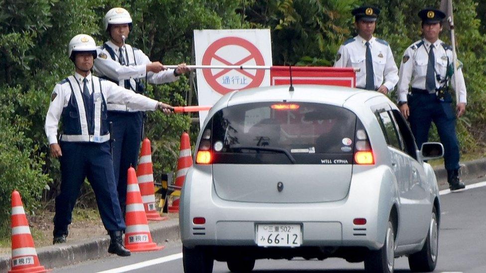 Policemen stand guard at a check point linking to the main venue of the G7 summit meeting in Shima, Mie prefecture, on May 25, 2016.