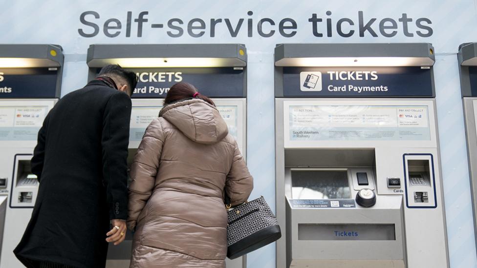 Couple at a ticket machine at Waterloo station