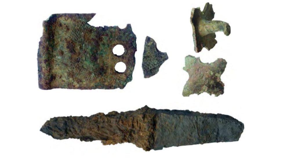 Decorative strap and studs and iron knife found at the site