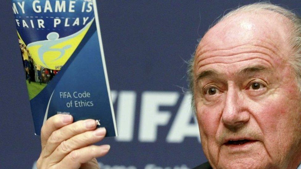 Fifa President Sepp Blatter displays a brochure containing the Fifa code of ethics as he addresses a news conference at the Fifa headquarters in Zurich, Switzerland (30 May 2011)