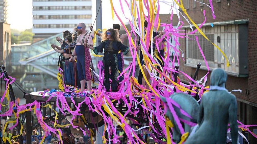 A large amount of confetti is dispersed as performers with the French acrobatics company Gratte Ciel conclude the world premiere of their show 'The Awakening' in Coventry, central England, on May 13, 2022