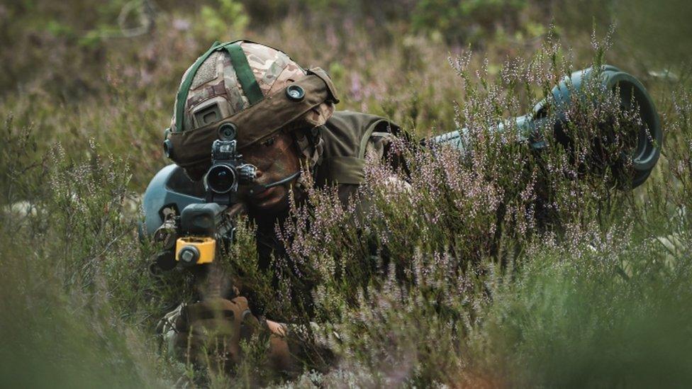 A soldier lying in the prone position