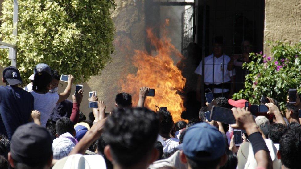 A host of mobile phones are raised to capture the moment Ricardo and Alberto Flores died