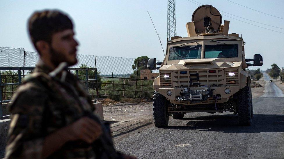 File photo showing a fighter of the Syrian Democratic Forces (SDF) standing guard along a road in the town of al-Busayrah, in Syria's Deir al-Zour province, on 4 September 2023