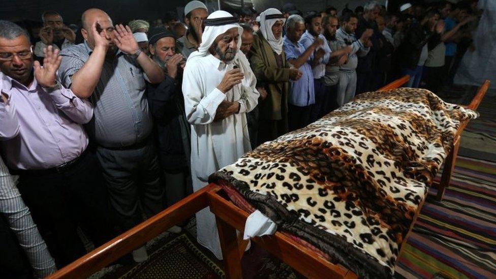 Mourners in Gaza pray during the funeral of the Palestinian woman who - according to medics - was killed by Israeli tank fire