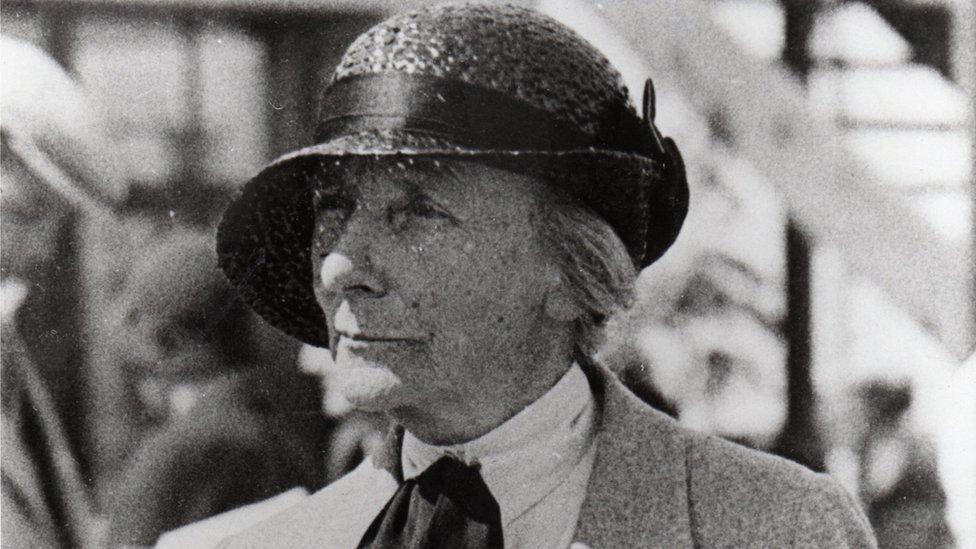 Dame Ethel Locke King in the paddock with a programme c.1935