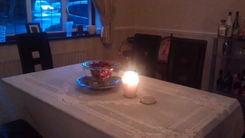 A candle lit where David Bowie used to take saxophone lessons.