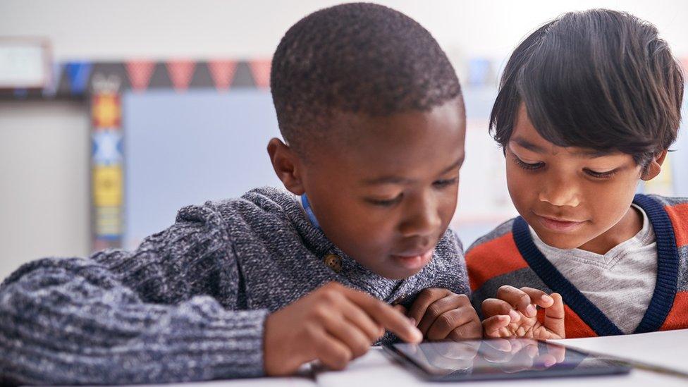 Two children using a tablet computer