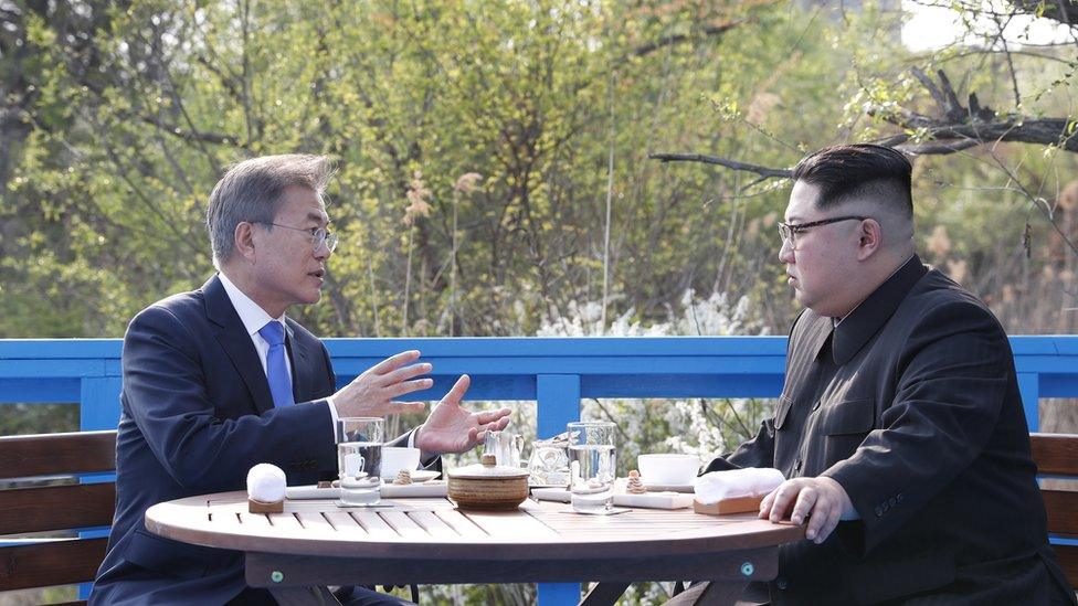 South Korean president Moon Jae-in and North Korean leader Kim Jong-un sat having a private conversation