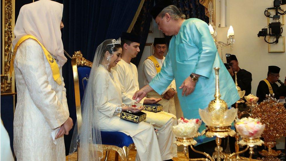 Princess Tunku Tun Aminah Sultan Ibrahim receives a blessing from her father, Johor Sultan Ibrahim Sultan Iskandar