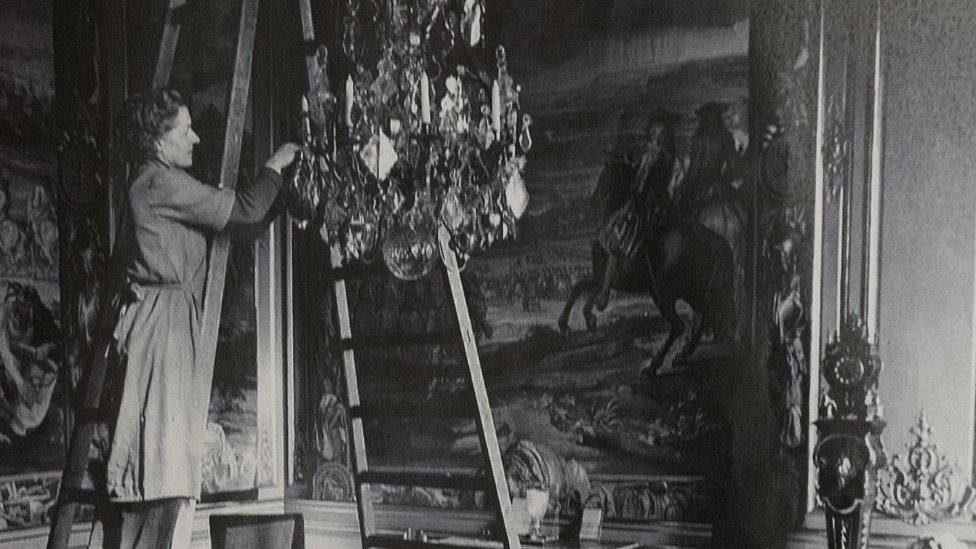 Cleaning a chandelier in 1950