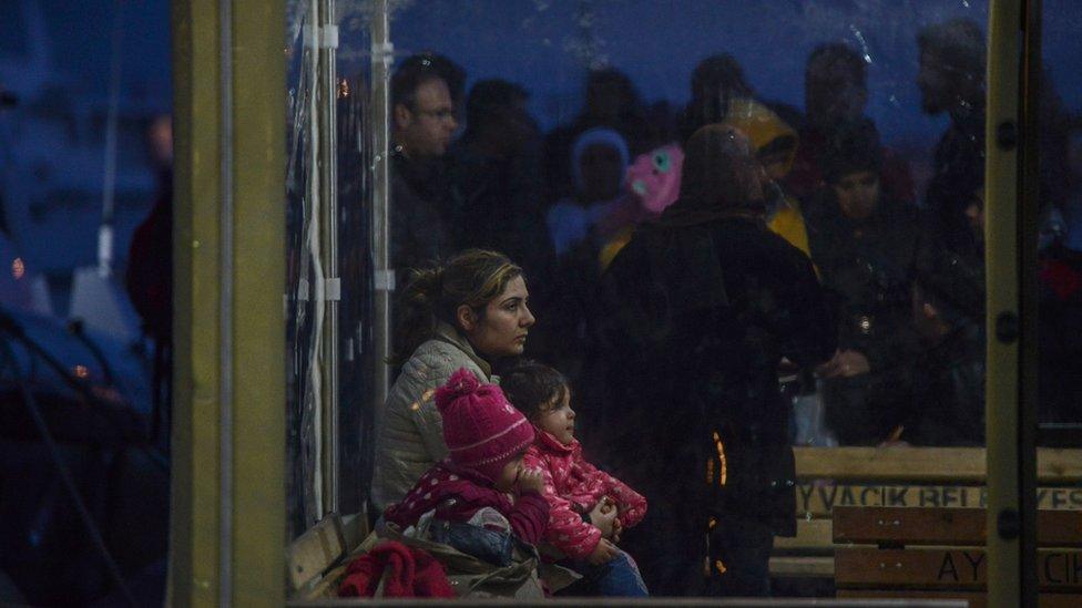 Syrian refugees are detained by the Turkish coastguard after they tried to reach the Greek island of Lesbos on March 3, 2016