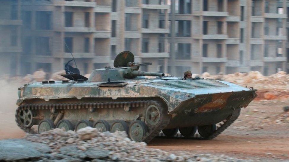 A Syrian rebel fighter drives an armoured vehicle in Aleppo, northern Syria. Photo: 5 August 2016