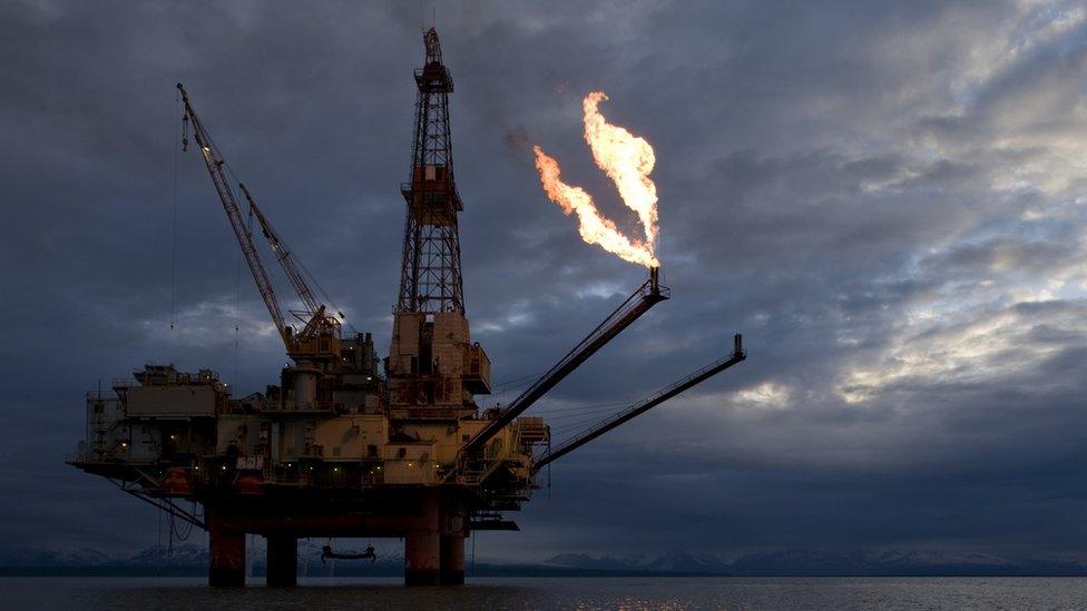 USA, Alaska, Natural gas flare from offshore oil drilling rig in Cook Inlet on summer evening