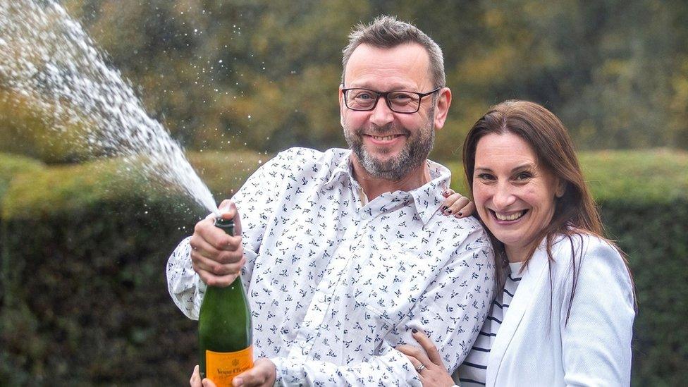 Andrea and Mike Law with some champagne