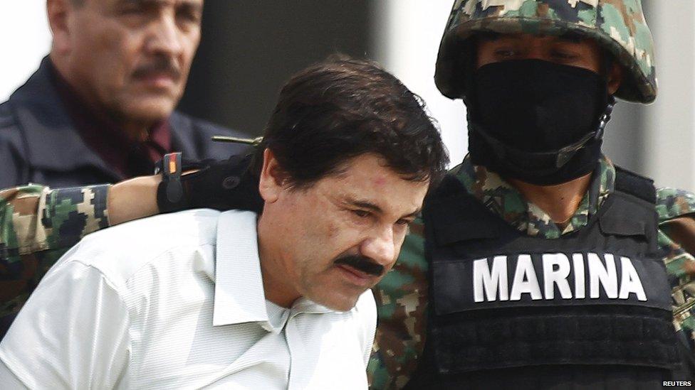 Joaquin "Shorty" Guzman (C) is escorted by soldiers during a presentation at the Navy"s airstrip in Mexico City in this February 22, 2014