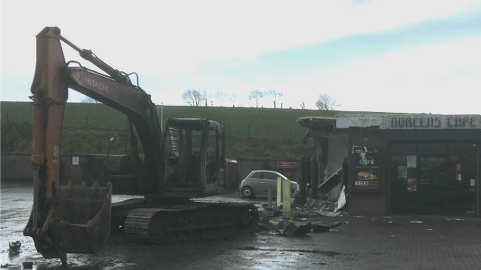 Digger outside filling station