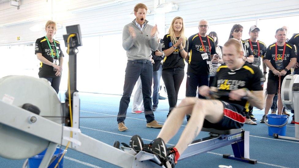 Prince Harry watches rowing competitors during the UK team trials