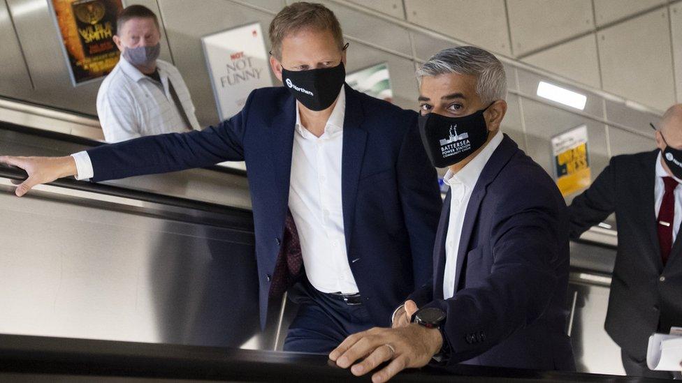 Mayor of London Sadiq Khan and Transport Secretary Grant Shapps travel on an escalator