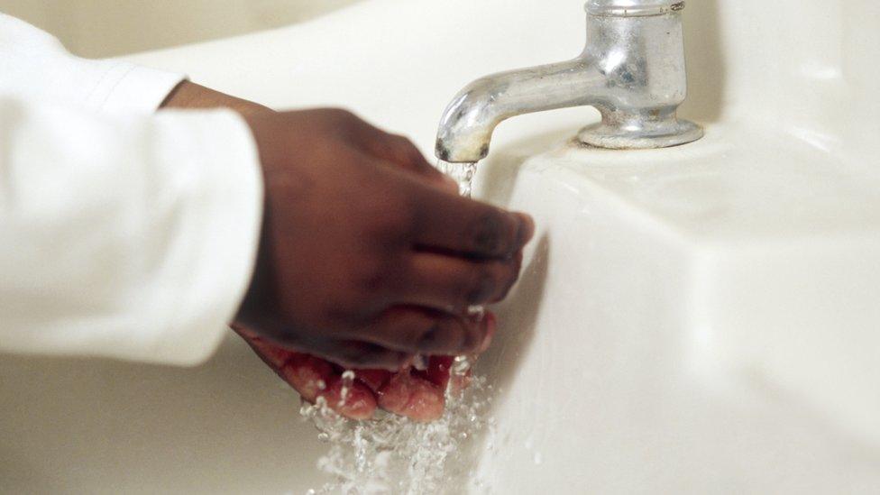 Child washing their hands