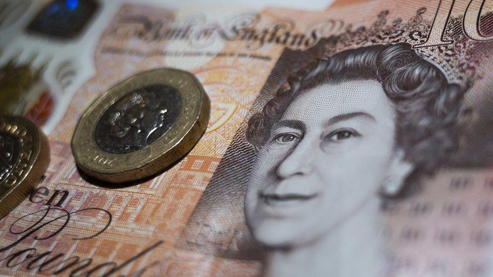 Banknote and coin with Queen's face on.