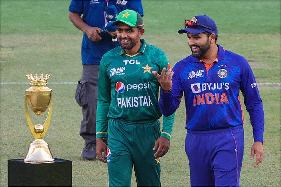 India's captain Rohit Sharma (R) and Pakistan's captain Babar Azam arrive for the toss before start of the Asia Cup Twenty20 international cricket Group A match between India and Pakistan at the Dubai International Cricket Stadium in Dubai on August 28, 2022