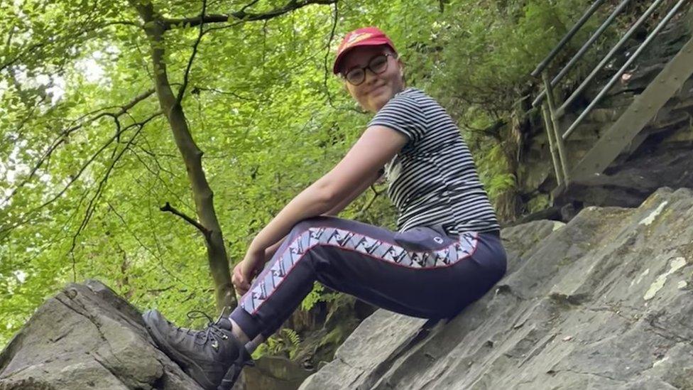 Saffron sitting on a rock