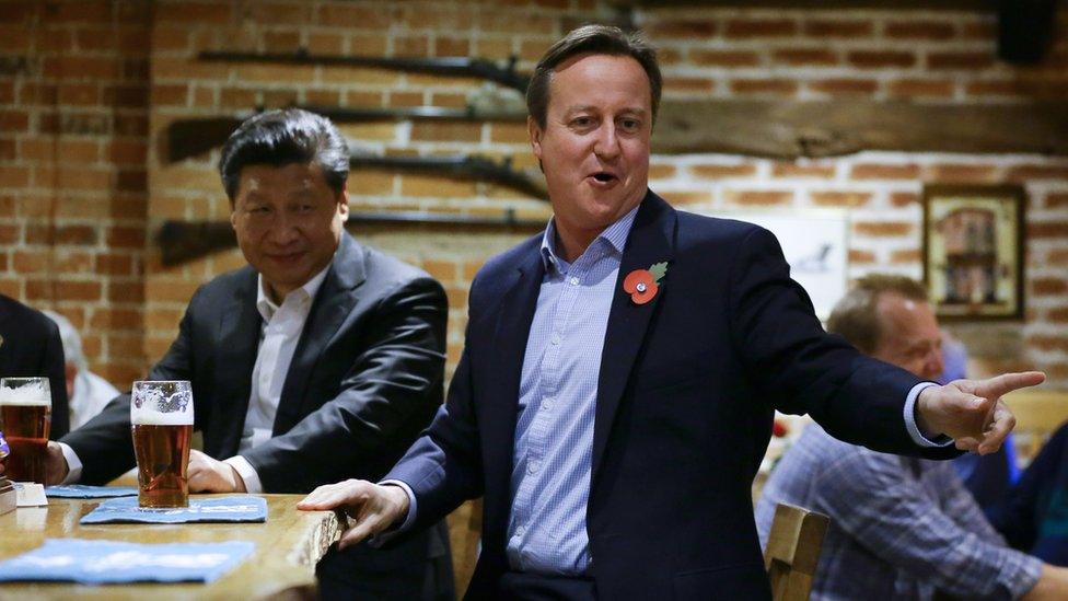 China's President Xi Jinping and Britain's Prime Minister David Cameron drink a pint of beer during a visit to the The Plough pub on October 22, 2015 in Princes Risborough, England.