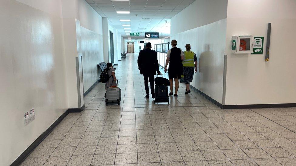 Madison, from Milton Keynes, and her dad Mark Baker wheeling their luggage through the airport