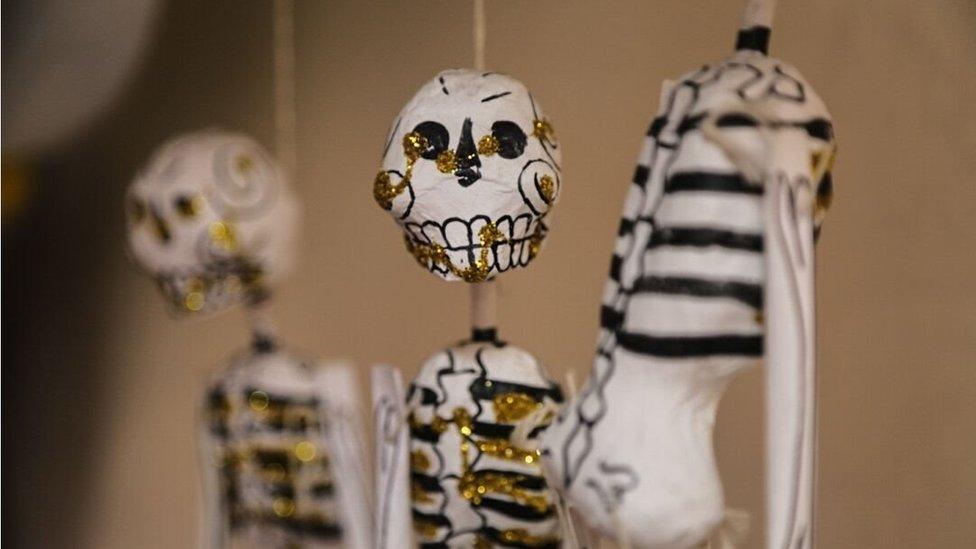 A close-up of papier mache skeletons