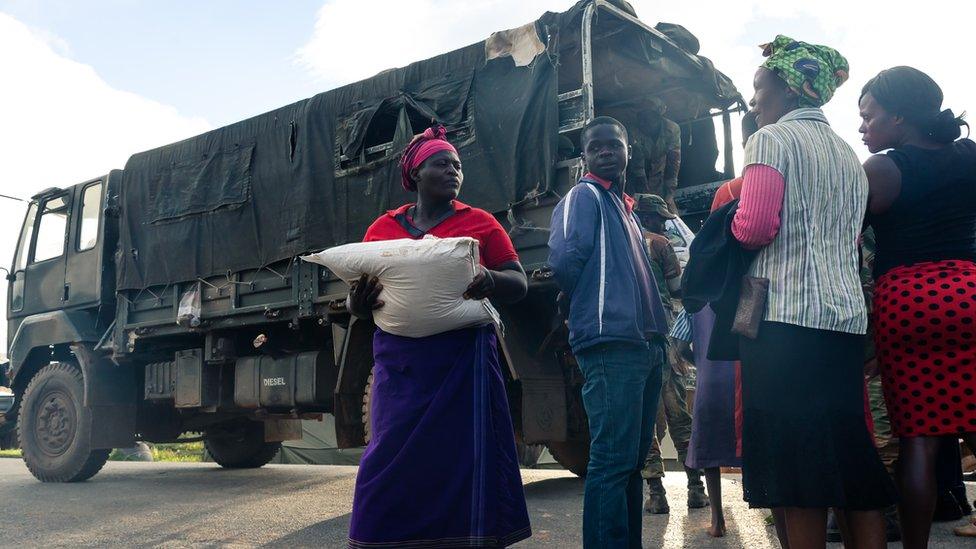 people collecting aid