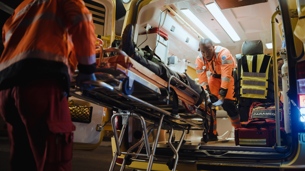 Ambulance paramedics with a stretcher