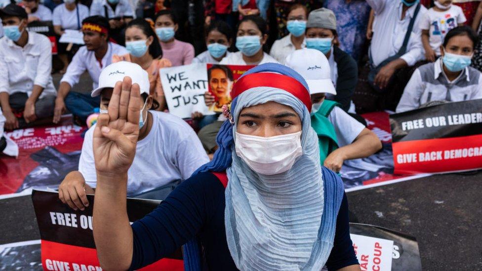 A protester in Myanmar's main city, Yangon, demonstrates against the coup, 22 February 2021