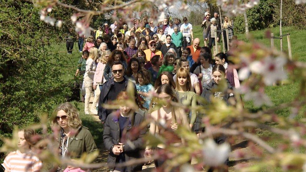 People take part in a walk in memory of Ruth Perry