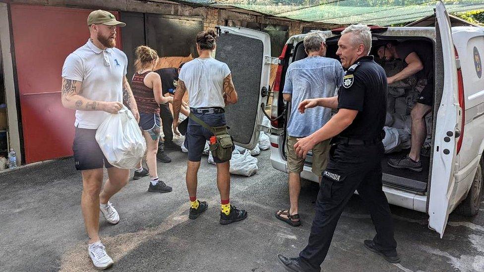 Aid workers unload supplies from a van in Ukraine