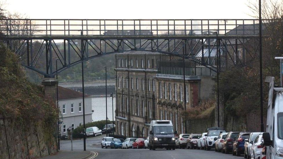 A van drives beneath the metal footbridge in North Shields